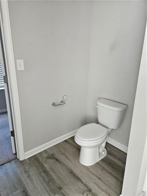 bathroom featuring hardwood / wood-style flooring and toilet