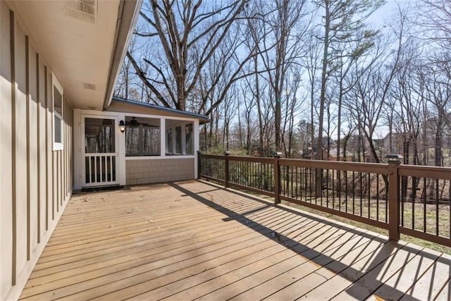 wooden deck featuring a sunroom