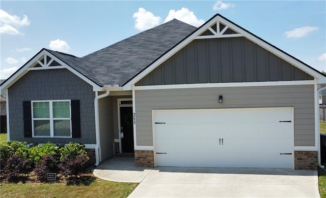 215 Barnyard Way, Perry, GA 31069 - craftsman-style house with board and batten siding, a garage, driveway, and roof with shingles
