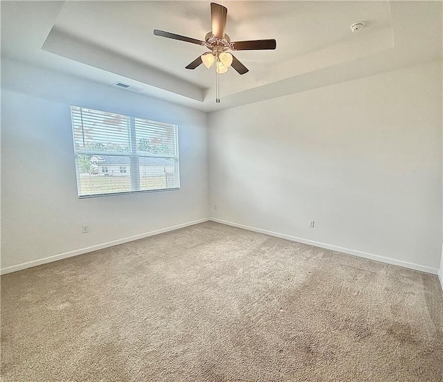 215 Barnyard Way, Perry, GA 31069 - empty room with a raised ceiling, carpet, a smoke detector, and a ceiling fan