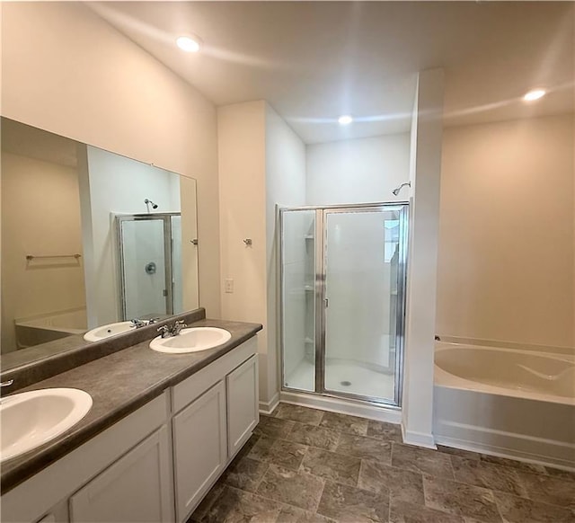 215 Barnyard Way, Perry, GA 31069 - bathroom with a shower stall, a garden tub, double vanity, stone finish floors, and baseboards
