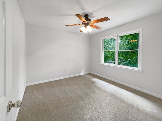 spare room featuring carpet and ceiling fan