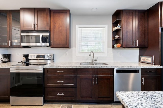 4284 Carlos Ct, Powder Springs, GA 30127 - kitchen with a sink, dark brown cabinets, open shelves, and stainless steel appliances