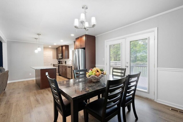 4284 Carlos Ct, Powder Springs, GA 30127 - dining room with visible vents, baseboards, ornamental molding, a chandelier, and light wood-style floors