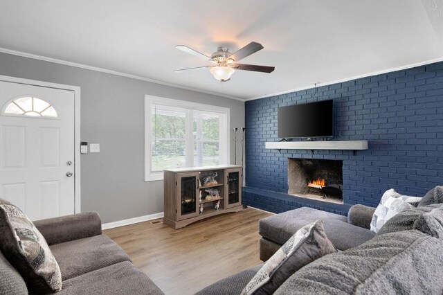 4284 Carlos Ct, Powder Springs, GA 30127 - living room featuring ornamental molding, a ceiling fan, wood finished floors, a brick fireplace, and baseboards