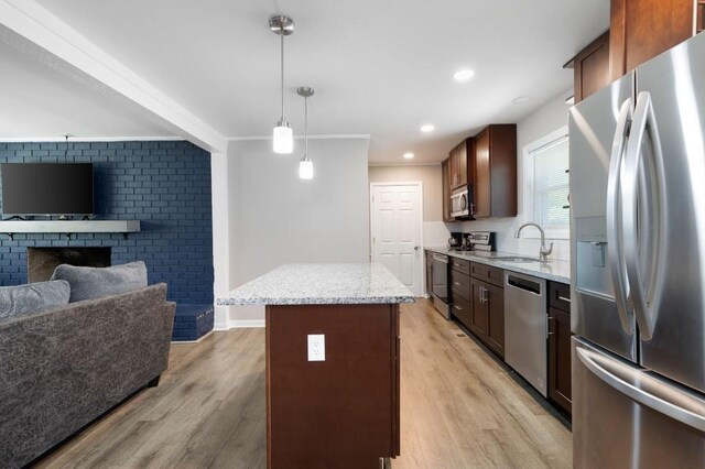 4284 Carlos Ct, Powder Springs, GA 30127 - kitchen with a sink, open floor plan, light wood-style floors, stainless steel appliances, and pendant lighting