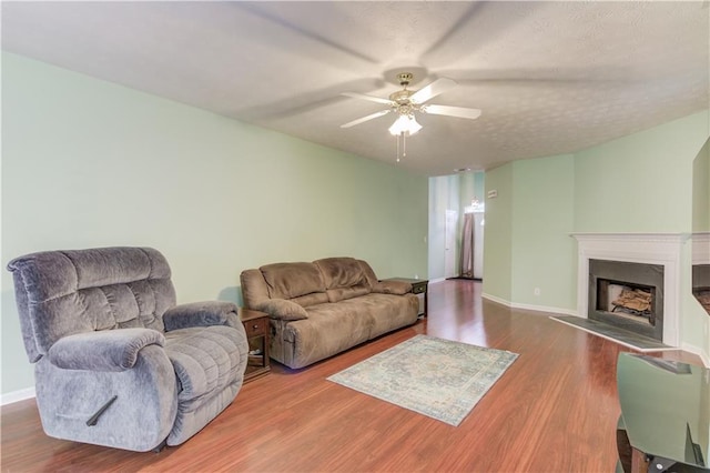 965 Under Ct, Sugar Hill, GA 30518 - living area featuring ceiling fan, wood finished floors, a fireplace with flush hearth, and baseboards