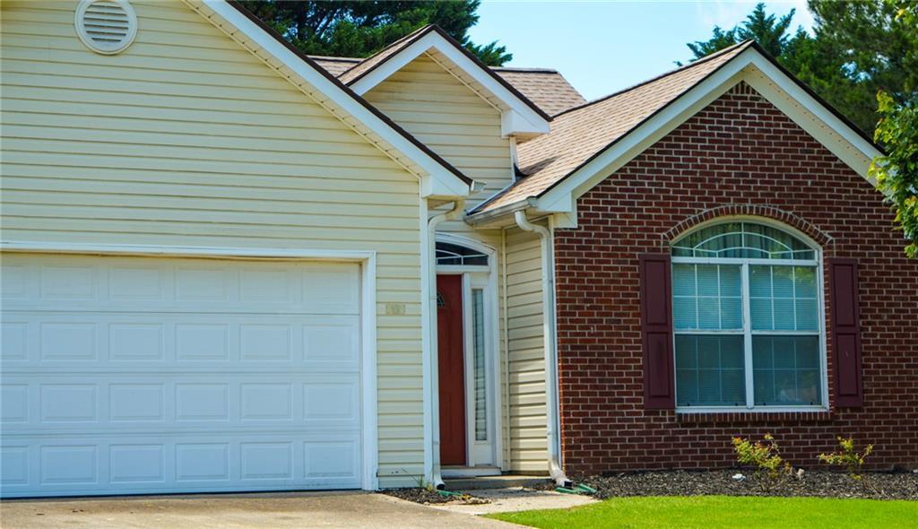 965 Under Ct, Sugar Hill, GA 30518 - single story home featuring an attached garage, brick siding, concrete driveway, and a shingled roof