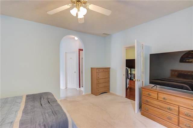 965 Under Ct, Sugar Hill, GA 30518 - bedroom with arched walkways, light colored carpet, ceiling fan, and baseboards