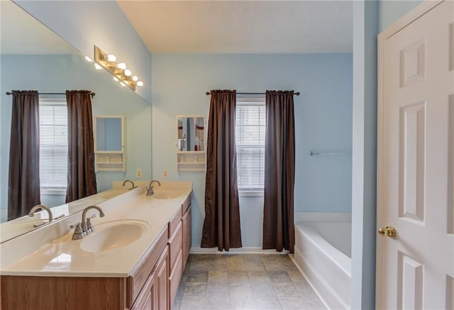 965 Under Ct, Sugar Hill, GA 30518 - bathroom featuring double vanity, a bathtub, and baseboards