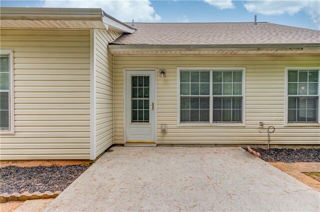 965 Under Ct, Sugar Hill, GA 30518 - property entrance with a patio and roof with shingles