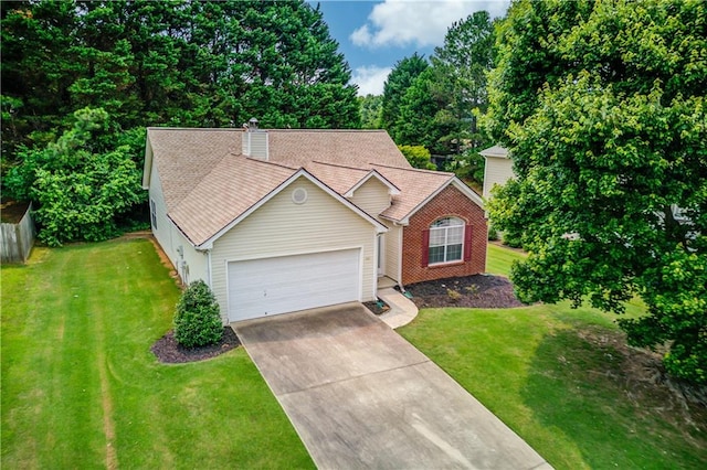965 Under Ct, Sugar Hill, GA 30518 - view of front of house featuring an attached garage, concrete driveway, a front yard, and a chimney