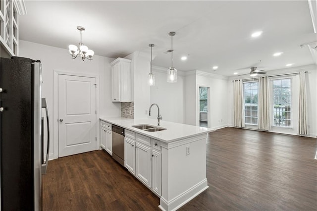 kitchen featuring pendant lighting, sink, stainless steel appliances, and white cabinets