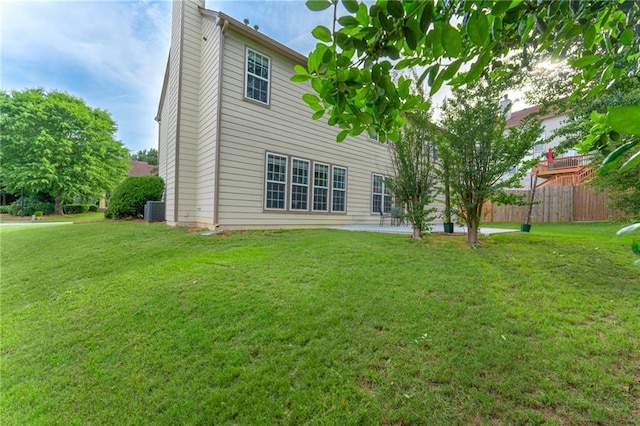 rear view of house with central AC unit and a patio area