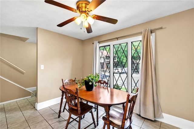 tiled dining room featuring ceiling fan