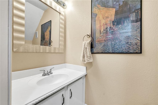 bathroom with vanity and vaulted ceiling