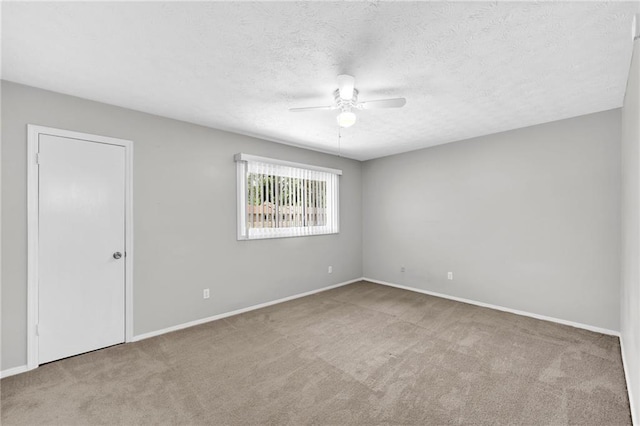 unfurnished room with light carpet, a textured ceiling, and ceiling fan