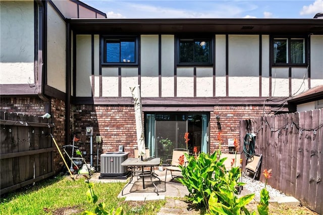 back of house featuring a patio area and central air condition unit