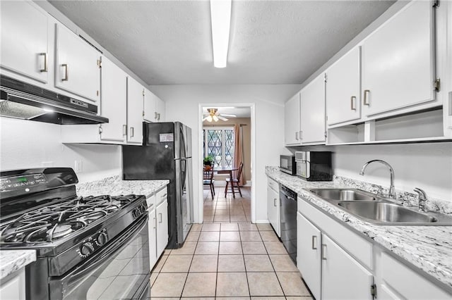 kitchen with ceiling fan, sink, black appliances, light tile patterned floors, and white cabinets