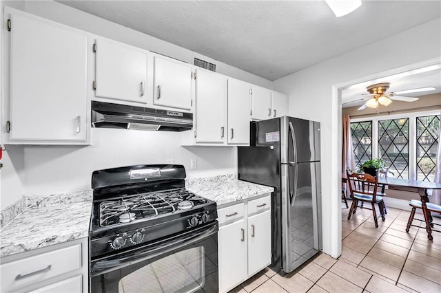 kitchen with white cabinets, stainless steel fridge, gas stove, and light tile patterned floors