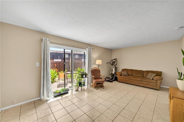 tiled living room featuring a textured ceiling