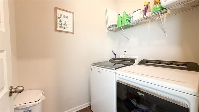 laundry room featuring laundry area, baseboards, and washing machine and clothes dryer