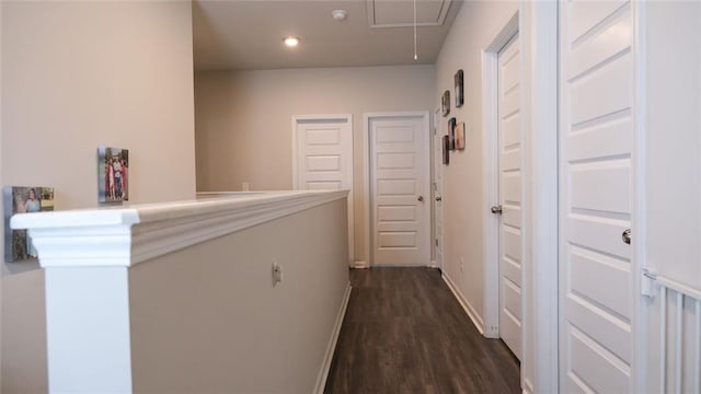 hall with dark wood-style flooring, baseboards, recessed lighting, and attic access