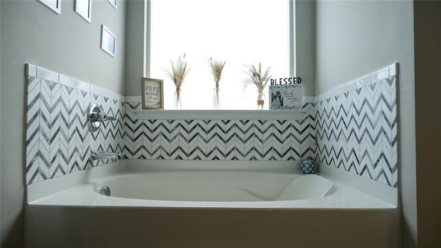 full bath featuring wainscoting and a garden tub