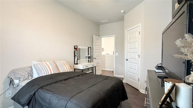 bedroom with baseboards and dark wood finished floors