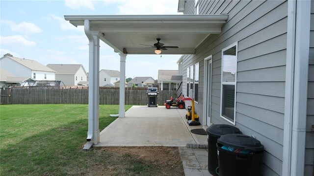 view of patio / terrace with ceiling fan, a residential view, and a fenced backyard