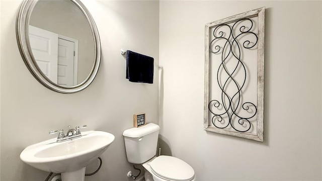half bathroom with a sink and toilet