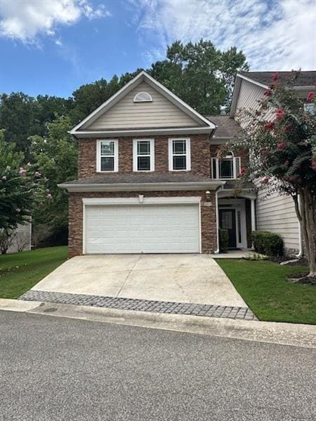 view of front of property featuring a garage and a front yard