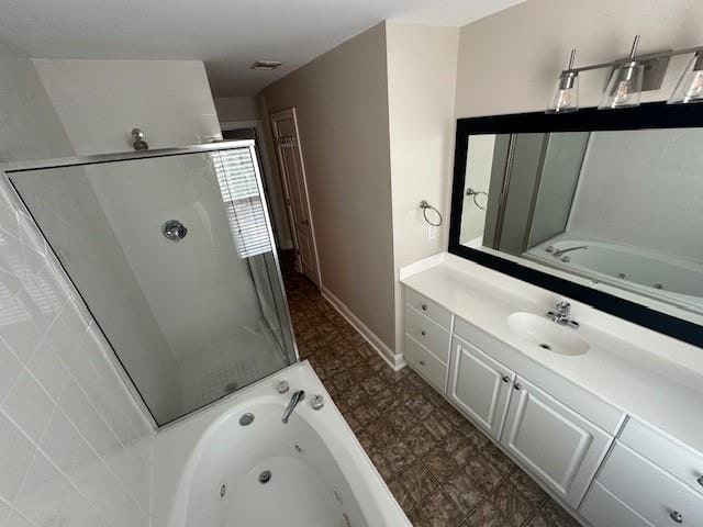 bathroom with vanity and independent shower and bath