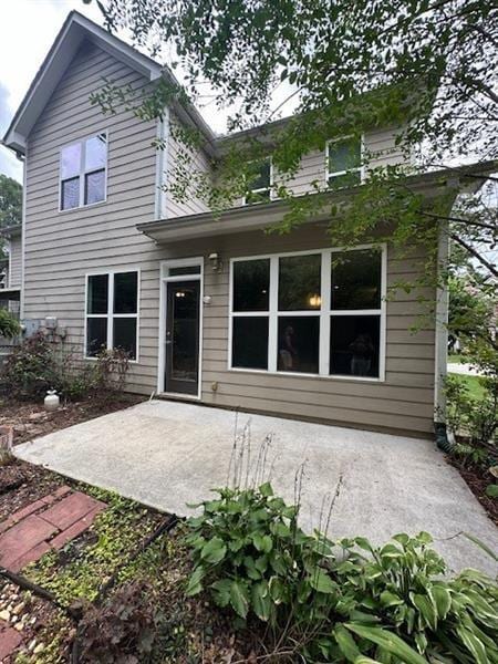 back of house with a patio