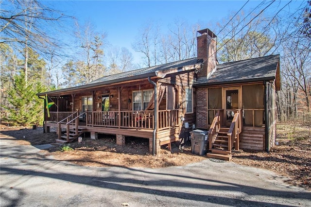 view of front facade featuring a porch and a sunroom