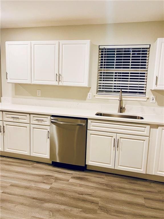 843 Kendall Park Dr, Winder, GA 30680 - kitchen featuring stainless steel dishwasher, white cabinetry, light countertops, and light wood-style flooring