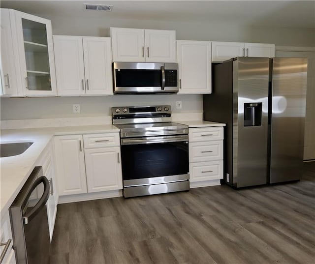 843 Kendall Park Dr, Winder, GA 30680 - kitchen featuring appliances with stainless steel finishes, white cabinets, and dark wood finished floors