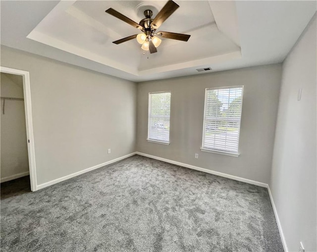 843 Kendall Park Dr, Winder, GA 30680 - unfurnished bedroom featuring a raised ceiling, carpet floors, and a ceiling fan