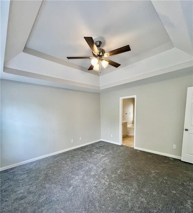843 Kendall Park Dr, Winder, GA 30680 - unfurnished bedroom with a raised ceiling, carpet, ceiling fan, and connected bathroom