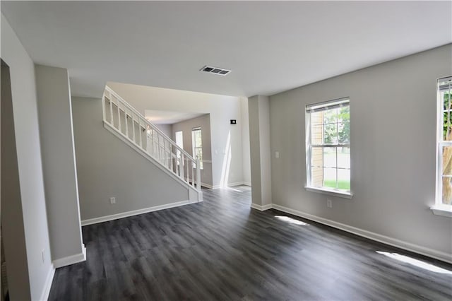 843 Kendall Park Dr, Winder, GA 30680 - unfurnished living room featuring dark wood-style floors and stairway