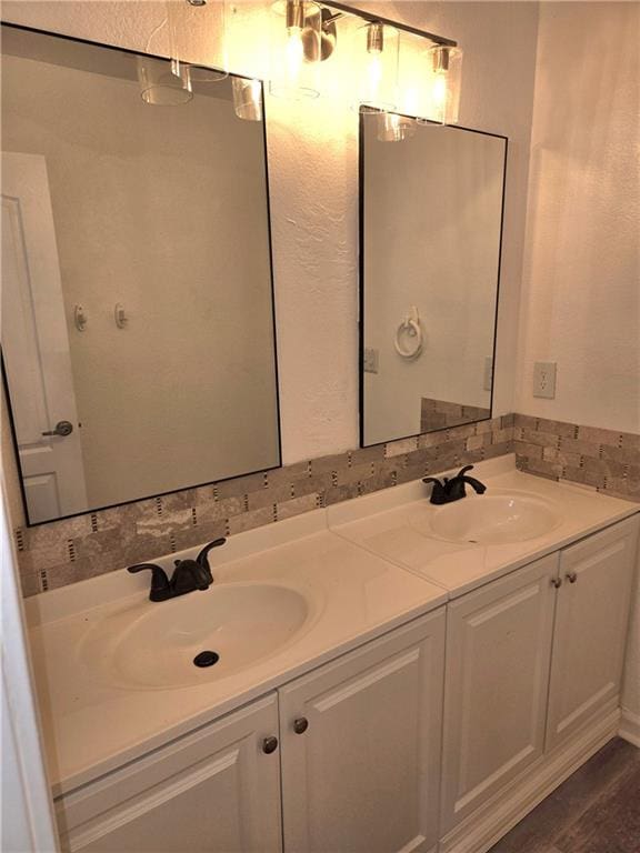 bathroom with hardwood / wood-style floors and vanity