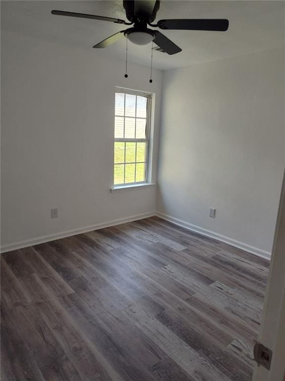 empty room featuring ceiling fan and dark hardwood / wood-style floors