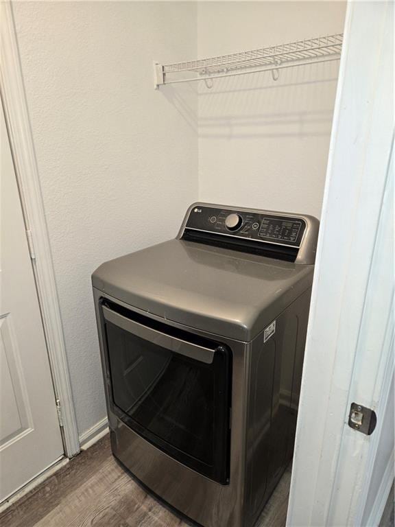 laundry area with washer / dryer and dark hardwood / wood-style floors