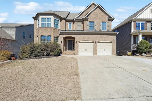 view of front of house with driveway, a garage, and brick siding