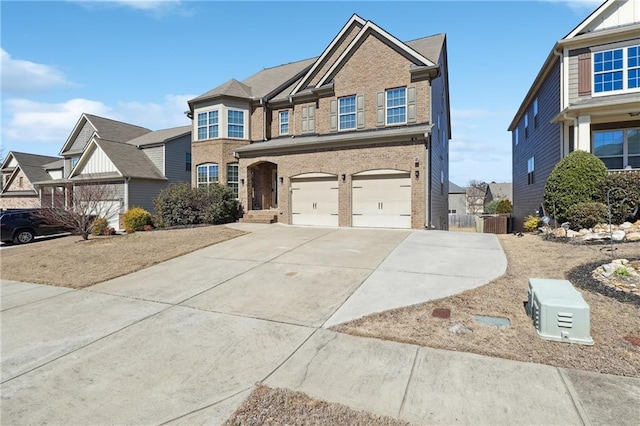 view of front of home featuring driveway, a garage, and brick siding