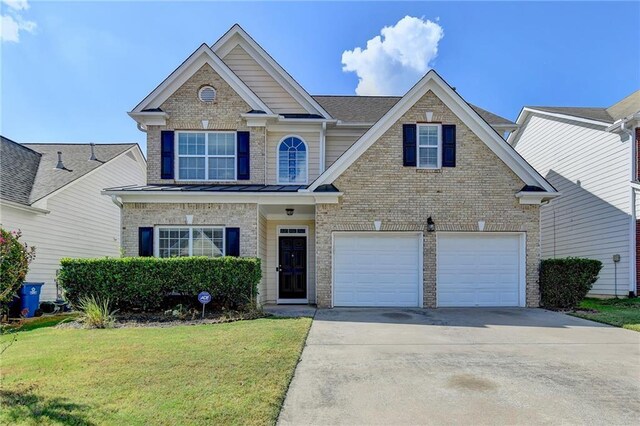 view of front of property featuring a garage and a front lawn