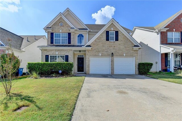 view of front of home with a garage and a front lawn