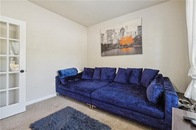 living room featuring light carpet and baseboards