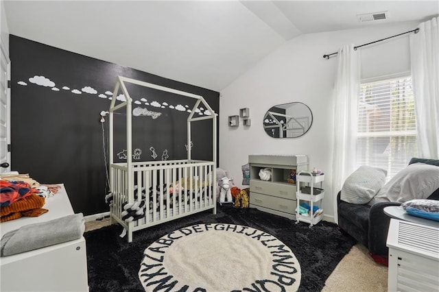 carpeted bedroom with lofted ceiling, a crib, and visible vents