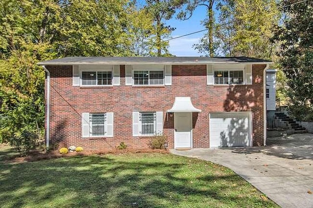 view of front of home with a garage and a front lawn